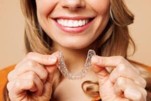 Woman holding a model of Invisalign at Westlake Village Dental