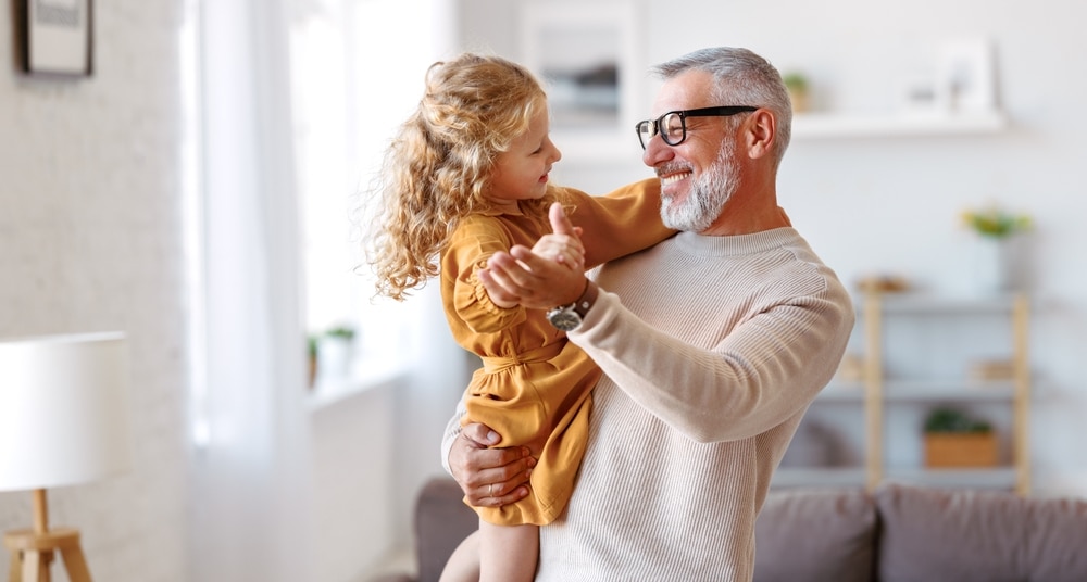 An older man dancing with a child at Dental Services at Westlake Village Dental